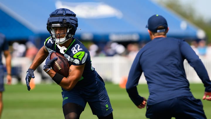 Jul 27, 2024; Renton, WA, USA; Seattle Seahawks wide receiver Cody White (82) carries the ball after making a catch during training camp at Virginia Mason Athletic Center. 