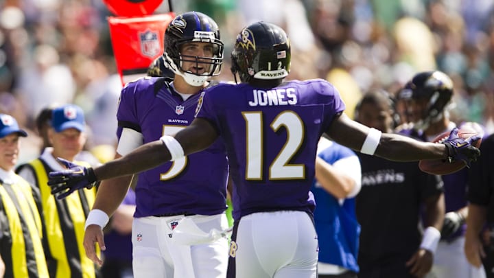 Sep 16, 2012; Philadelphia, PA, USA; Baltimore Ravens quarterback Joe Flacco (5) celebrates a touchdown with wide receiver Jacoby Jones (12) during the second quarter against the Philadelphia Eagles at Lincoln Financial Field. Mandatory Credit: Howard Smith-Imagn Images