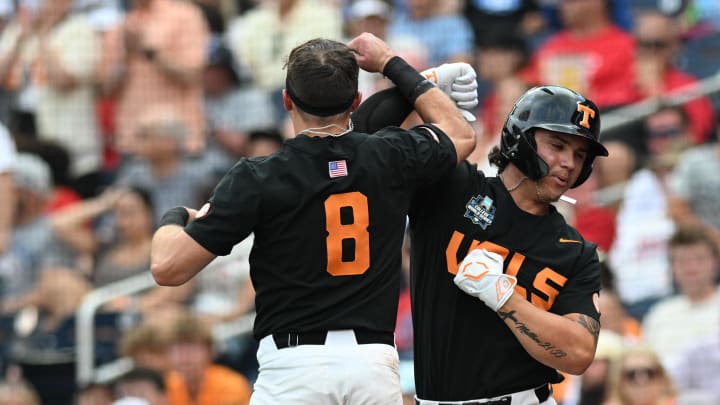 Jun 16, 2024; Omaha, NE, USA; Tennessee Volunteers designated hitter Reese Chapman (13) celebrates a home run with left fielder Dylan Dreiling (8) during the fifth inning at Charles Schwab Field Omaha. Mandatory Credit: Steven Branscombe-USA TODAY Sports