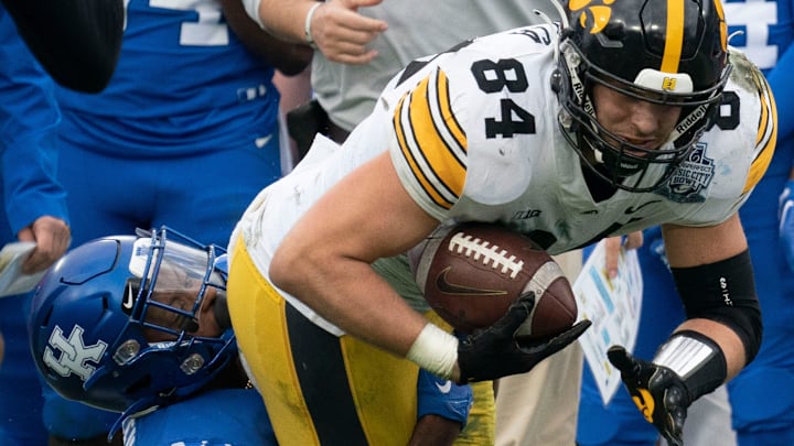 Iowa tight end Sam LaPorta is pulled down by a Kentucky defender during the fourth quarter of the