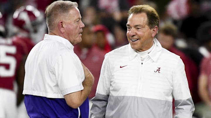 Nov 4, 2023; Tuscaloosa, Alabama, USA;  LSU Tigers head coach Brian Kelly and Alabama Crimson Tide head coach Nick Saban talk together at midfield before the Alabama vs LSU game at Bryant-Denny Stadium. Mandatory Credit: Gary Cosby Jr.-Imagn Images