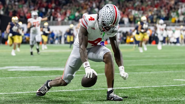 Jan 20, 2025; Atlanta, GA, USA; Ohio State Buckeyes wide receiver Jeremiah Smith (4) celebrates a play against the Notre Dame Fighting Irish during the CFP National Championship college football game at Mercedes-Benz Stadium. Mandatory Credit: Mark J. Rebilas-Imagn Images