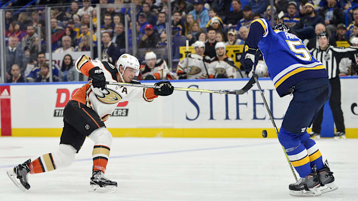 Dec 14, 2017; St. Louis, MO, USA; Anaheim Ducks defenseman Cam Fowler (4) shoots as St. Louis Blues defenseman Colton Parayko (55) defends during the second period at Scottrade Center. Mandatory Credit: Jeff Curry-Imagn Images