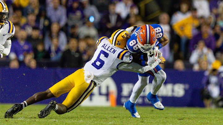 Nov 11, 2023; Baton Rouge, Louisiana, USA; LSU Tigers safety Jordan Allen (6) tackles Florida Gators wide receiver Marcus Burke (88)  during the second half at Tiger Stadium. Mandatory Credit: Stephen Lew-Imagn Images