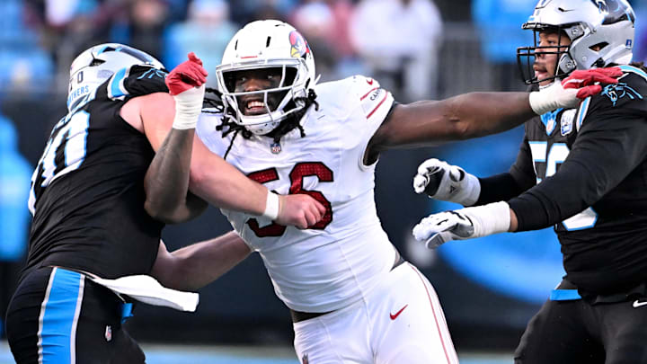 Dec 22, 2024; Charlotte, North Carolina, USA; Arizona Cardinals defensive end Darius Robinson (56) rushes as Carolina Panthers guard Brady Christensen (70) and guard Robert Hunt (50) defend in overtime at Bank of America Stadium. Mandatory Credit: Bob Donnan-Imagn Images Dec 22, 2024; Charlotte, North Carolina, USA; Arizona Cardinals defensive end Darius Robinson (56) rushes as Carolina Panthers guard Brady Christensen (70) and guard Robert Hunt (50) defend in overtime at Bank of America Stadium. Mandatory Credit: Bob Donnan-Imagn Images