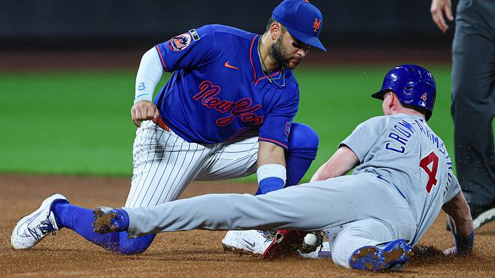 Jun 23, 2026; New York City, New York, USA; Chicago Cubs center fielder Pete Crow-Armstrong (4) slides through second base as New York Mets third baseman Bo Bichette (19) tags during the seventh inning at Citi Field. Review determined Crow-Armstrong was out. Mandatory Credit: Vincent Carchietta-Imagn Images