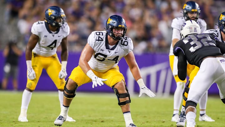Oct 23, 2021; Fort Worth, Texas, USA; West Virginia Mountaineers offensive lineman Wyatt Milum (64) steps back to block during the third quarter against the TCU Horned Frogs at Amon G. Carter Stadium. Mandatory Credit: Ben Queen-Imagn Images