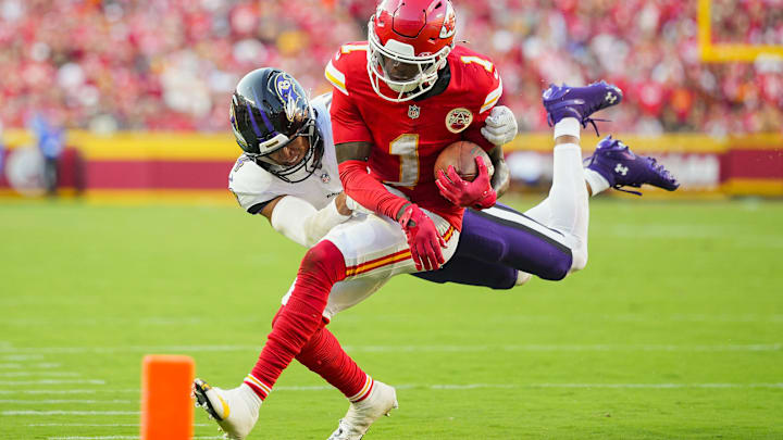 Sep 28, 2025; Kansas City, Missouri, USA; Kansas City Chiefs wide receiver Xavier Worthy (1) is tackled by Baltimore Ravens safety Kyle Hamilton (14) during the second half at GEHA Field at Arrowhead Stadium. Mandatory Credit: Jay Biggerstaff-Imagn Images