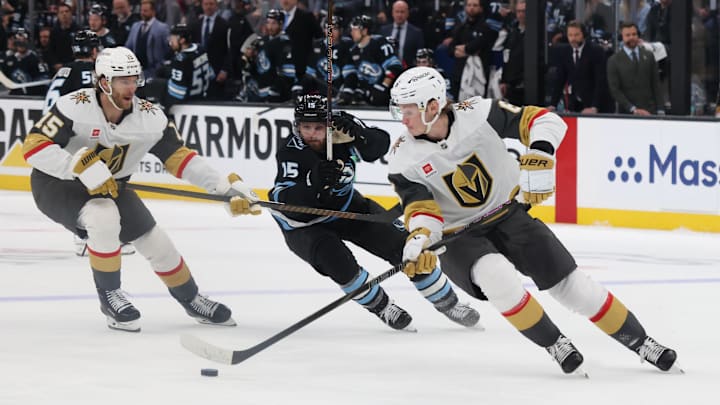 Apr 24, 2026; Salt Lake City, Utah, USA; Vegas Golden Knights defenseman Kaedan Korczak (6) controls the puck against Utah Mammoth center Alexander Kerfoot (15) during the third period in game three of the first round of the 2026 Stanley Cup Playoffs at Delta Center. Mandatory Credit: Rob Gray-Imagn Images