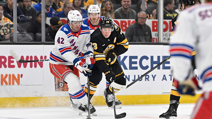 Oct 4, 2025; Boston, Massachusetts, USA; New York Rangers center Matt Rempe (73) and New York Rangers center Noah Laba (42) battle for control of the puck during the first period at TD Garden. Mandatory Credit: Eric Canha-Imagn Images