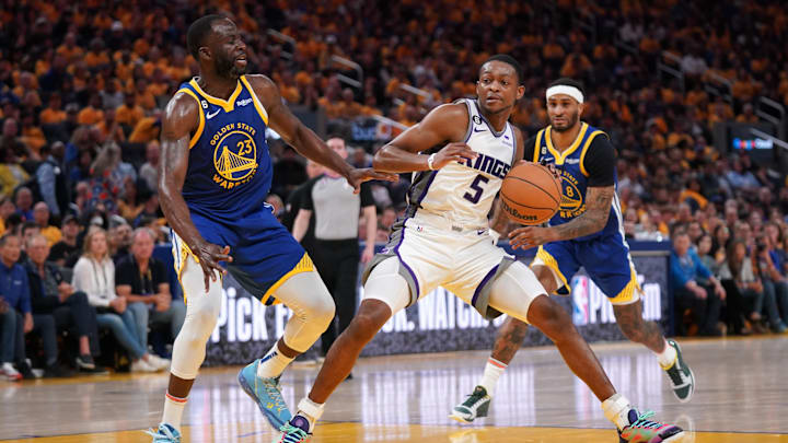 Apr 28, 2023; San Francisco, California, USA; Sacramento Kings guard De'Aaron Fox (5) holds onto the ball next to Golden State Warriors forward Draymond Green (23) in the third quarter during game six of the 2023 NBA playoffs at the Chase Center. Mandatory Credit: Cary Edmondson-Imagn Images Apr 28, 2023; San Francisco, California, USA; Sacramento Kings guard De'Aaron Fox (5) holds onto the ball next to Golden State Warriors forward Draymond Green (23) in the third quarter during game six of the 2023 NBA playoffs at the Chase Center. Mandatory Credit: Cary Edmondson-Imagn Images