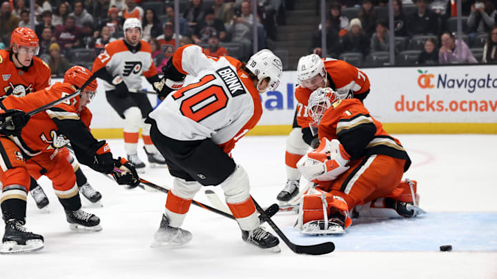 Dec 28, 2024; Anaheim, California, USA;  Philadelphia Flyers right wing Bobby Brink (10) fights for the puck against Anaheim Ducks goaltender Lukas Dostal (1) during the first period at Honda Center. Mandatory Credit: Kiyoshi Mio-Imagn Images