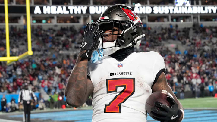 Dec 1, 2024; Charlotte, North Carolina, USA; Tampa Bay Buccaneers running back Bucky Irving (7) blows a kiss to the crowd after scoring a touchdown in the fourth quarter at Bank of America Stadium. Mandatory Credit: Bob Donnan-Imagn Images