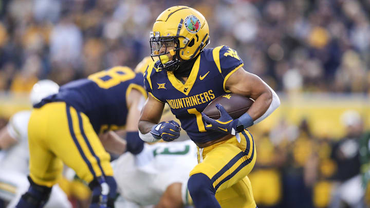 Nov 16, 2024; Morgantown, West Virginia, USA; West Virginia Mountaineers running back Jahiem White (1) runs the ball during the first quarter against the Baylor Bears at Mountaineer Field at Milan Puskar Stadium. Mandatory Credit: Ben Queen-Imagn Images