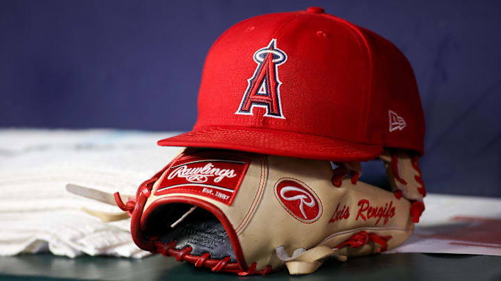Aug 1, 2023; Atlanta, Georgia, USA; A detailed view of a Los Angeles Angels hat and glove on the bench against the Atlanta Braves in the eighth inning at Truist Park. Mandatory Credit: Brett Davis-Imagn Images