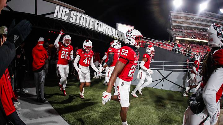 Nov 29, 2025; Raleigh, North Carolina, USA; NC State Wolfpack takes to the field during the warmups of the game against North Carolina Tar Heels at Carter-Finley Stadium. Mandatory Credit: Jaylynn Nash-Imagn Images Nov 29, 2025; Raleigh, North Carolina, USA; NC State Wolfpack takes to the field during the warmups of the game against North Carolina Tar Heels at Carter-Finley Stadium. Mandatory Credit: Jaylynn Nash-Imagn Images