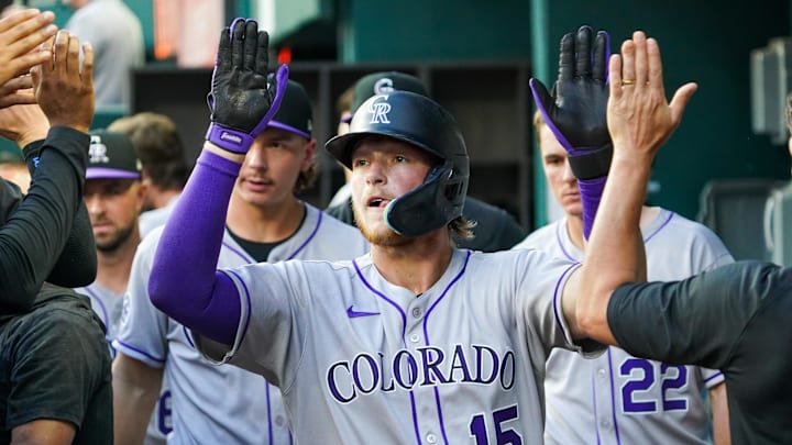 May 12, 2025; Arlington, Texas, USA; Colorado Rockies catcher Hunter Goodman (15) high fives teammates after scoring during the second inning against the Texas Rangers at Globe Life Field. Mandatory Credit: Raymond Carlin III-Imagn Images