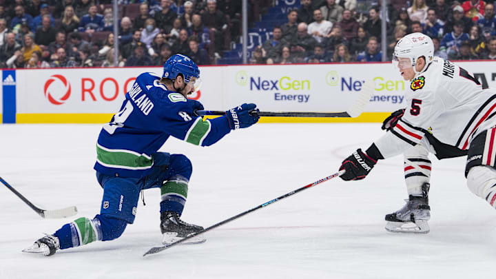 Apr 6, 2023; Vancouver, British Columbia, CAN; Vancouver Canucks forward Conor Garland (8) shoots around Chicago Blackhawks defenseman Connor Murphy (5) in the third period at Rogers Arena. Canucks won 3-0. Mandatory Credit: Bob Frid-Imagn Images