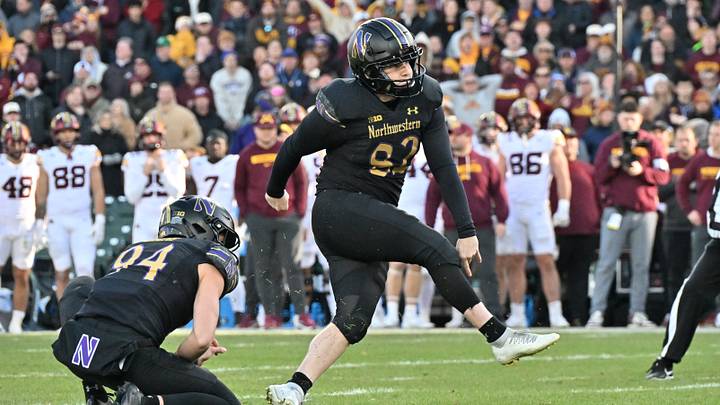Nov 22, 2025; Chicago, Illinois, USA; Northwestern Wildcats kicker Jack Olsen (82) kicks the game winning field goal against the Minnesota Golden Gophers during the second half at Wrigley Field. Mandatory Credit: Patrick Gorski-Imagn Images