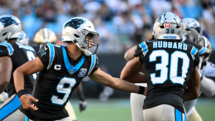 Nov 3, 2024; Charlotte, North Carolina, USA; Carolina Panthers quarterback Bryce Young (9) hands the ball off to Carolina Panthers running back Chuba Hubbard (30) in the fourth qarter at Bank of America Stadium. Mandatory Credit: Bob Donnan-Imagn Images