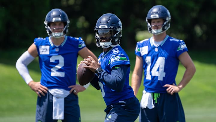 Jun 11, 2025; Renton, WA, USA; Seattle Seahawks quarterback Jalen Milroe (6) looks to pass as quarterback Drew Lock (2) and quarterback Sam Darnold (14) during mini-camp at Virginia Mason Athletic Center. Mandatory Credit: Stephen Brashear-Imagn Images Jun 11, 2025; Renton, WA, USA; Seattle Seahawks quarterback Jalen Milroe (6) looks to pass as quarterback Drew Lock (2) and quarterback Sam Darnold (14) during mini-camp at Virginia Mason Athletic Center. Mandatory Credit: Stephen Brashear-Imagn Images