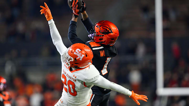 Nov 8, 2025; Corvallis, Oregon, USA; Oregon State Beavers wide receiver David Wells Jr. (1) makes a catch on the sideline with Sam Houston Bearkats defensive back Dravon Wilson (20) defending during the second half at Reser Stadium. Mandatory Credit: Craig Strobeck-Imagn Images