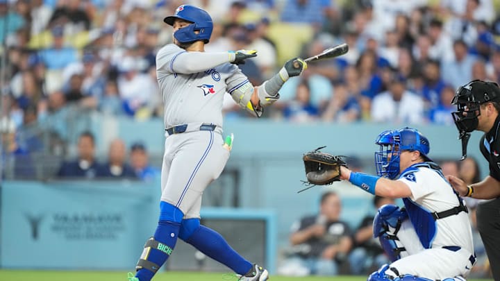 Aug 8, 2025; Los Angeles, California, USA; Toronto Blue Jays shortstop Bo Bichette (11) hits a double during the second inning against the Los Angeles Dodgers at Dodger Stadium. 