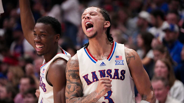 Dec 22, 2025; Lawrence, Kansas, USA; Kansas Jayhawks guard Melvin Council Jr. (14) and guard Tre White (3) celebrate on the bench against the Davidson Wildcats during the second half of the game at Allen Fieldhouse. Mandatory Credit: Denny Medley-Imagn Images