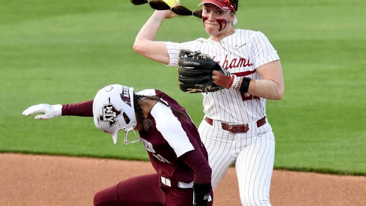 April 15, 2024; Tuscaloosa, AL, USA; Alabama infielder Kali Heivilin (22) forces out Texas A&M runner Kramer Eschete at second as she makes the turn for a double play attempt at Rhoads Stadium Monday.
