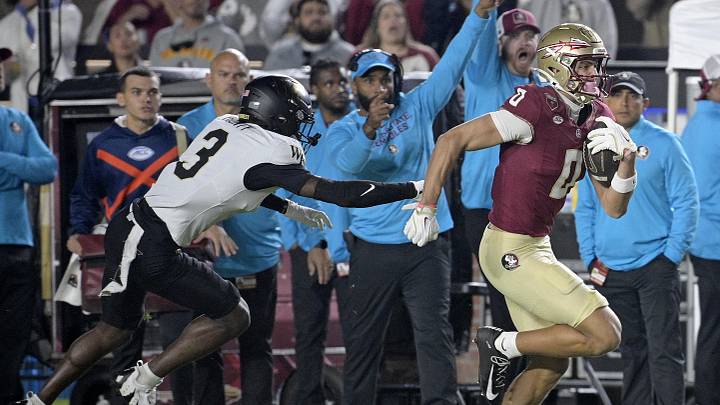 Nov 1, 2025; Tallahassee, Florida, USA; Florida State Seminoles wide receiver Duce Robinson (0) runs with the ball past the defense of Wake Forest Demon Deacons defensive back Karon Prunty (3) during the first quarter at Doak S. Campbell Stadium. Mandatory Credit: Melina Myers-Imagn Images Nov 1, 2025; Tallahassee, Florida, USA; Florida State Seminoles wide receiver Duce Robinson (0) runs with the ball past the defense of Wake Forest Demon Deacons defensive back Karon Prunty (3) during the first quarter at Doak S. Campbell Stadium. Mandatory Credit: Melina Myers-Imagn Images