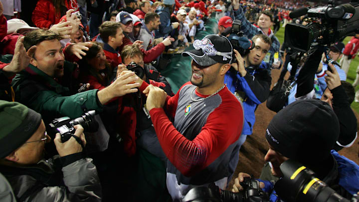 Oct 27, 2006; St. Louis, MO, USA; St. Louis Cardinals first baseman Albert Pujols celebrates with fans after defeating the Detroit Tigers 4-2 during game 5 of the World Series to win the series 4 games to 1 at Busch Stadium in St. Louis, Missouri. Mandatory Credit: Jerry Lai-Imagn Images Copyright © 2006 Jerry Lai Oct 27, 2006; St. Louis, MO, USA; St. Louis Cardinals first baseman Albert Pujols celebrates with fans after defeating the Detroit Tigers 4-2 during game 5 of the World Series to win the series 4 games to 1 at Busch Stadium in St. Louis, Missouri. Mandatory Credit: Jerry Lai-Imagn Images Copyright © 2006 Jerry Lai