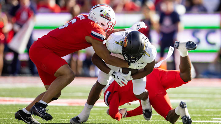 Oct 19, 2024; Tucson, Arizona, USA; Arizona Wildcats linebacker Taye Brown (6) tackles Colorado Buffalos running back Dallan Hayden (7) at Arizona Stadium. Mandatory Credit: Mark J. Rebilas-Imagn Images Oct 19, 2024; Tucson, Arizona, USA; Arizona Wildcats linebacker Taye Brown (6) tackles Colorado Buffalos running back Dallan Hayden (7) at Arizona Stadium. Mandatory Credit: Mark J. Rebilas-Imagn Images