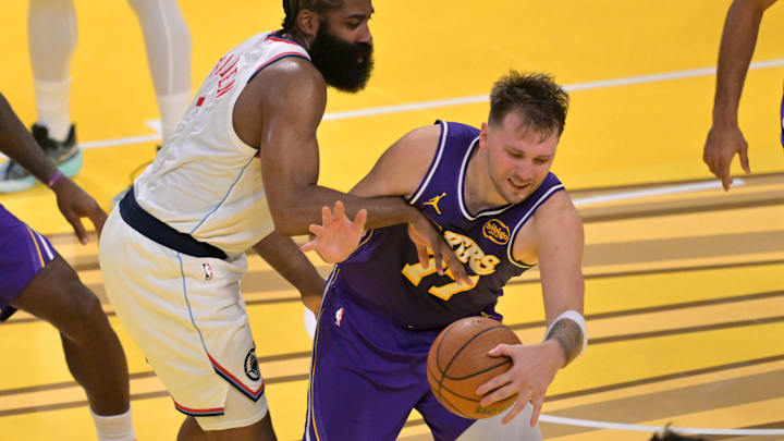 Nov 25, 2025; Los Angeles, California, USA;  Los Angeles Clippers guard James Harden (1) fouls Los Angeles Lakers guard Luka Doncic (77) in the second half at Crypto.com Arena. Mandatory Credit: Jayne Kamin-Oncea-Imagn Images