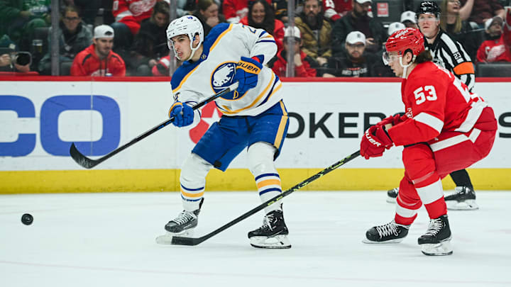 Apr 6, 2023; Detroit, Michigan, USA; Buffalo Sabres center Dylan Cozens (24) shoots as Detroit Red Wings defenseman Moritz Seider (53) defends during the third period at Little Caesars Arena. Mandatory Credit: Tim Fuller-Imagn Images