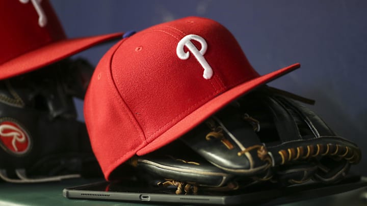 May 25, 2022; Atlanta, Georgia, USA; Detailed view of a Philadelphia Phillies hat and glove in the dugout against the Atlanta Braves in the eighth inning at Truist Park. May 25, 2022; Atlanta, Georgia, USA; Detailed view of a Philadelphia Phillies hat and glove in the dugout against the Atlanta Braves in the eighth inning at Truist Park.
