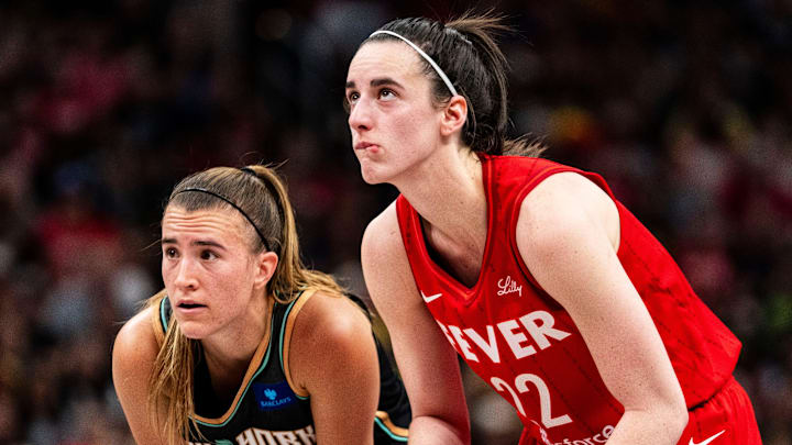 New York Liberty guard Sabrina Ionescu (20) and Indiana Fever guard Caitlin Clark (22) watch a free throw Saturday, July 6, 2024, during the game at Gainbridge Fieldhouse in Indianapolis.