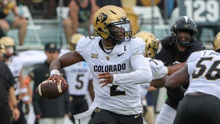 Sep 28, 2024; Orlando, Florida, USA; Colorado Buffaloes quarterback Shedeur Sanders (2) rolls out to pass against the UCF Knights during the first quarter at FBC Mortgage Stadium. Mandatory Credit: Mike Watters-Imagn Images
