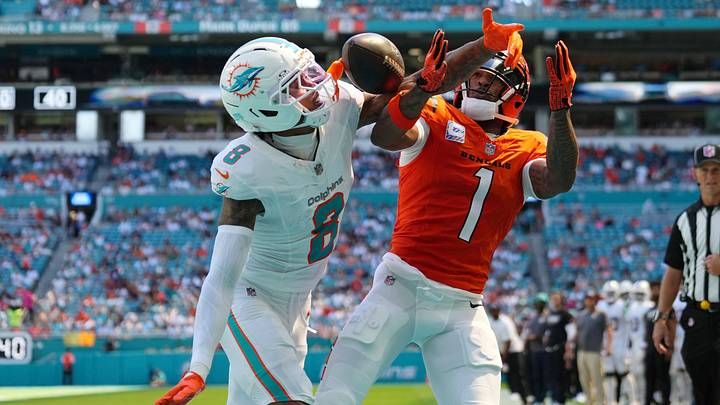 Miami Dolphins cornerback JuJu Brents (8) and Cincinnati Bengals wide receiver Ja'Marr Chase (1) battle for the ball during the first quarter at Hard Rock Stadium.
