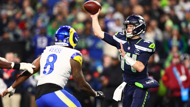 Seattle Seahawks quarterback Sam Darnold (14) throws against Los Angeles Rams linebacker Jared Verse (8).