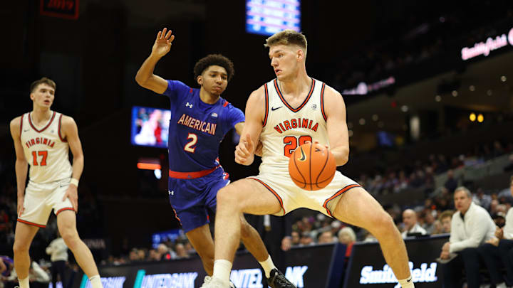 Dec 22, 2025; Charlottesville, Virginia, USA; Virginia Cavaliers forward Thijs de Ridder (28) drives to the basket as American University Eagles guard Madden Collins (2) defends in the second half at John Paul Jones Arena. Mandatory Credit: Geoff Burke-Imagn Images