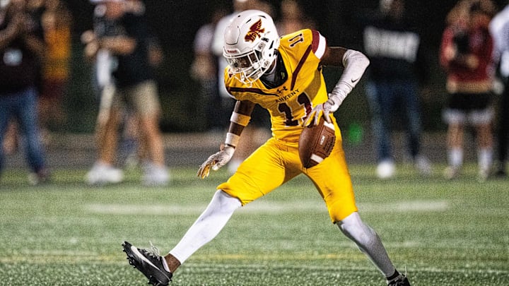 Ankeny's LaMarious Clark (11) celebrates after intercepting the Dowling offense on Friday, Sept. 13, 2024, at Ankeny Stadium.