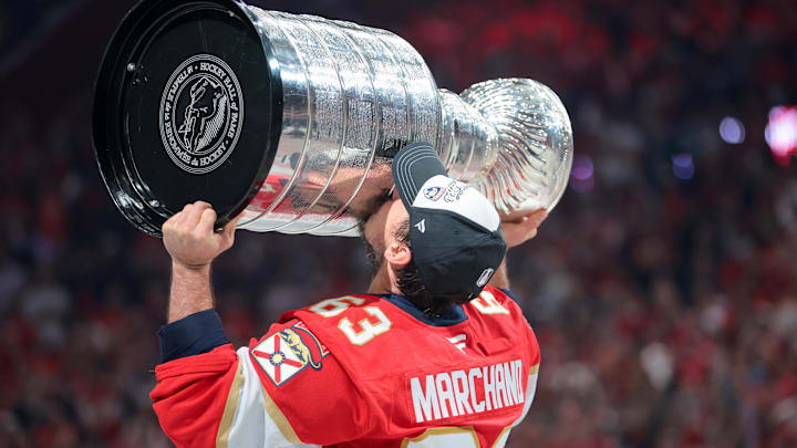 Jun 17, 2025; Sunrise, Florida, USA; Florida Panthers center Brad Marchand (63) hoists the Stanley Cup after winning game six of the 2025 Stanley Cup Final against the Edmonton Oilers at Amerant Bank Arena. Mandatory Credit: Sam Navarro-Imagn Images