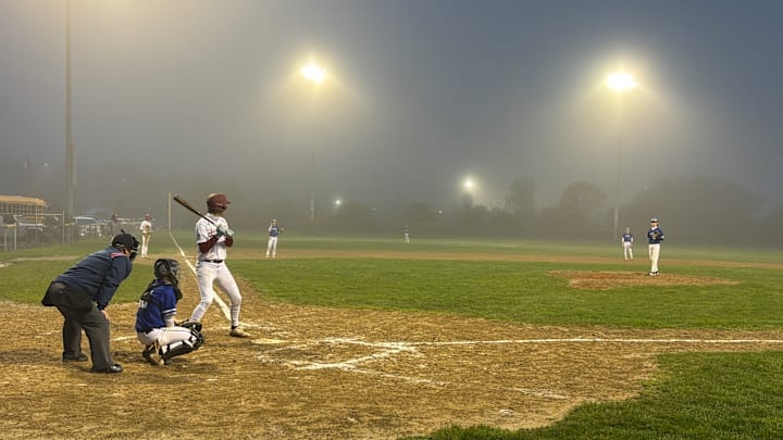 Gloucester takes the plate under the lights amidst the fog at O'malley Field