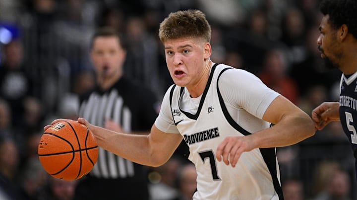 Jan 24, 2026; Providence, Rhode Island, USA; Providence Friars guard Stefan Vaaks (7) drives the ball to the basket against Georgetown Hoyas guard KJ Lewis (5) during the first half at Amica Mutual Pavilion. Mandatory Credit: Eric Canha-Imagn Images