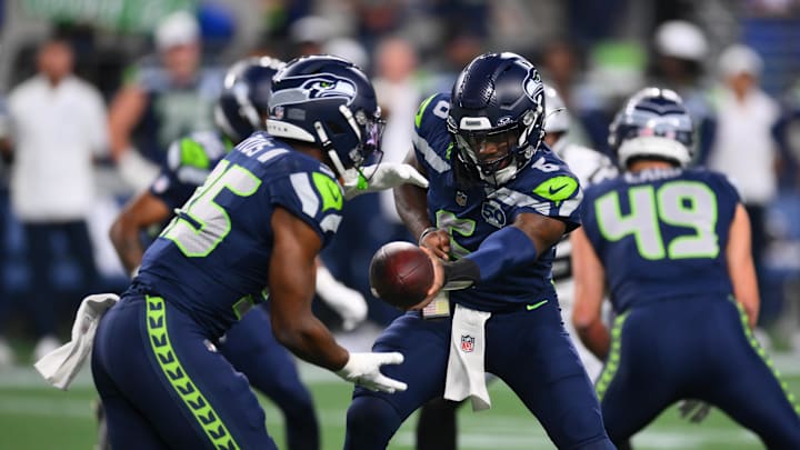 Aug 7, 2025; Seattle, Washington, USA; Seattle Seahawks quarterback Jalen Milroe (6) hands the ball off to running back Anthony Tyus III (35) during the second half at Lumen Field. Mandatory Credit: Steven Bisig-Imagn Images