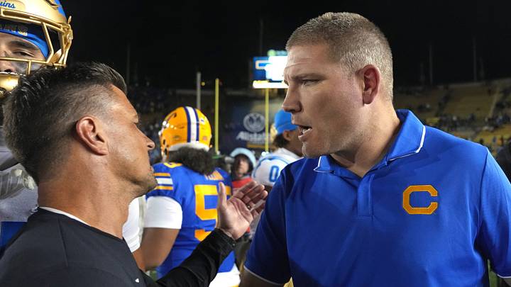 Cal head coach Tosh Lupoi (right) congratulates UCLA coach Bob Chesney after UCLA's victory Cal head coach Tosh Lupoi (right) congratulates UCLA coach Bob Chesney after UCLA's victory