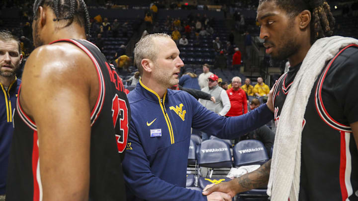 Jan 29, 2025; Morgantown, West Virginia, USA; West Virginia Mountaineers head coach Darian DeVries shakes hands with Houston Cougars forward Ja'Vier Francis (5) after the game at WVU Coliseum. Mandatory Credit: Ben Queen-Imagn Images Jan 29, 2025; Morgantown, West Virginia, USA; West Virginia Mountaineers head coach Darian DeVries shakes hands with Houston Cougars forward Ja'Vier Francis (5) after the game at WVU Coliseum. Mandatory Credit: Ben Queen-Imagn Images