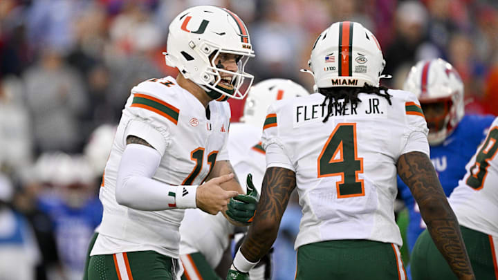 Nov 1, 2025; Dallas, Texas, USA;  Miami Hurricanes quarterback Carson Beck (11) sets the play with running back Mark Fletcher Jr. (4) during the first quarter against the SMU Mustangs at Gerald J. Ford Stadium. Mandatory Credit: Jerome Miron-Imagn Images