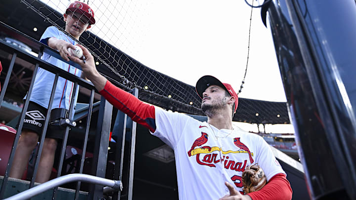 Aug 29, 2023; St. Louis, Missouri, USA;  St. Louis Cardinals third baseman Nolan Arenado (28) signs an autograph for a fan before a game against the San Diego Padres at Busch Stadium. Mandatory Credit: Jeff Curry-Imagn Images