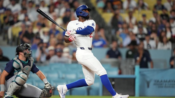 Aug 20, 2024; Los Angeles, California, USA;  Los Angeles Dodgers right fielder Jason Heyward (23) hits a three-run home run in the eighth inning as Seattle Mariners catcher Cal Raleigh (29) watches at Dodger Stadium.